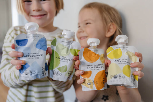 toddlers with white leaf puree pouches to make meal prep easy!