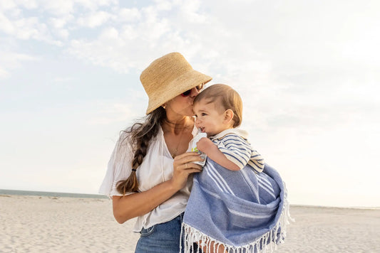 mom on beach with toddler enjoying White Leaf Provisions puree as part of healthy summer snacks for kids