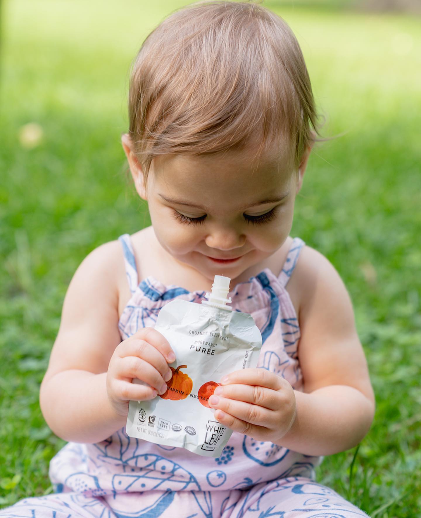 baby eating pumpkin baby food pouch